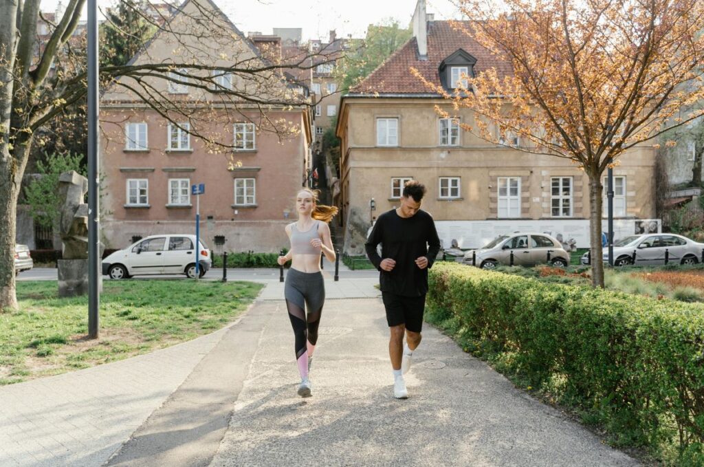 photo of Couple jogging in a park